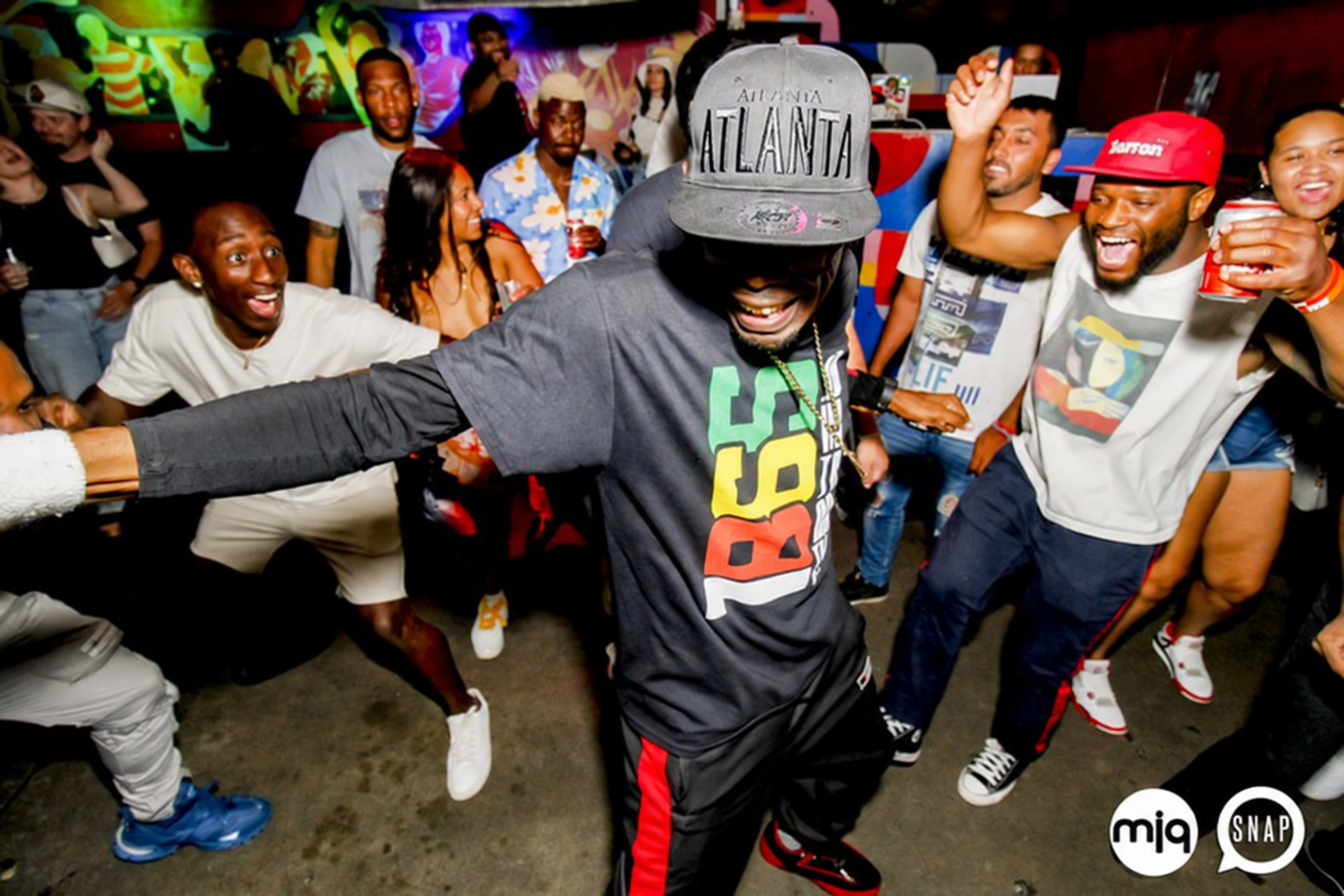 PopaDok dancing with focused intensity inside a crowded Atlanta cypher